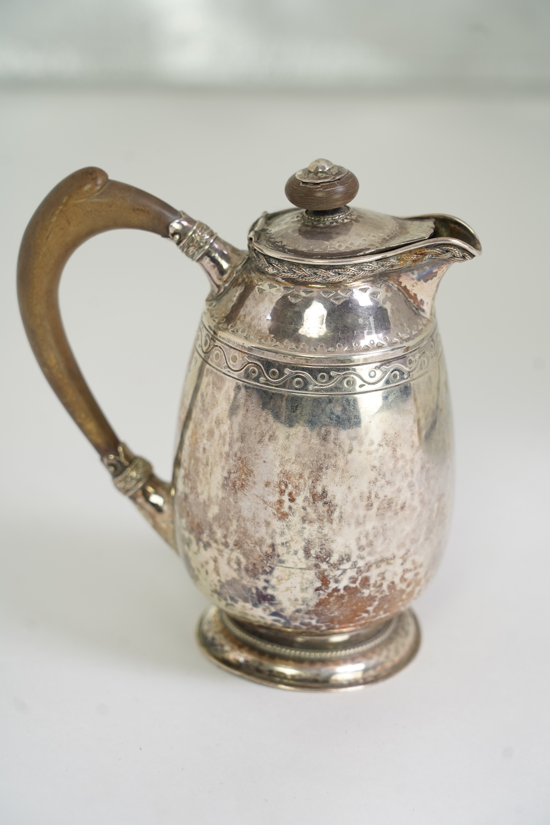 A George V Arts & Crafts silver hot water pot by Liberty & Co